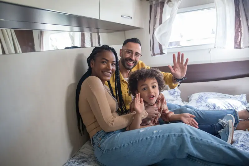 Joyful family enjoying quality time together in a cozy camper van