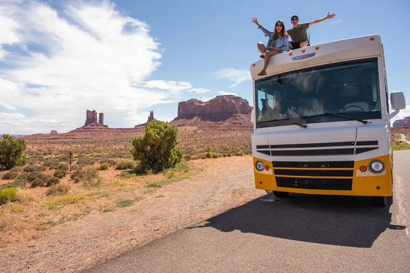 Couple enjoying a summer RV road trip in Monument Valley, Utah