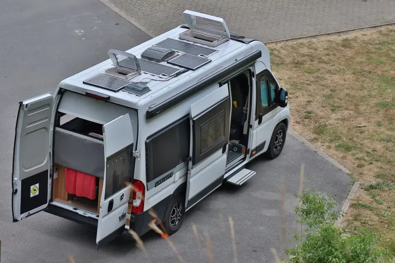 Top view of a campervan parked outdoors with solar panels, symbolizing vanlife in Bouillon, Belgium